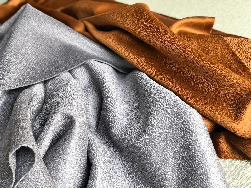 Grey and brown textured fabrics arranged side by side in folds